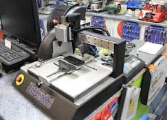 Professional key cutting machine at Ashton Lock & Key â€” precision cutting for all key types in Ashton-in-Makerfield